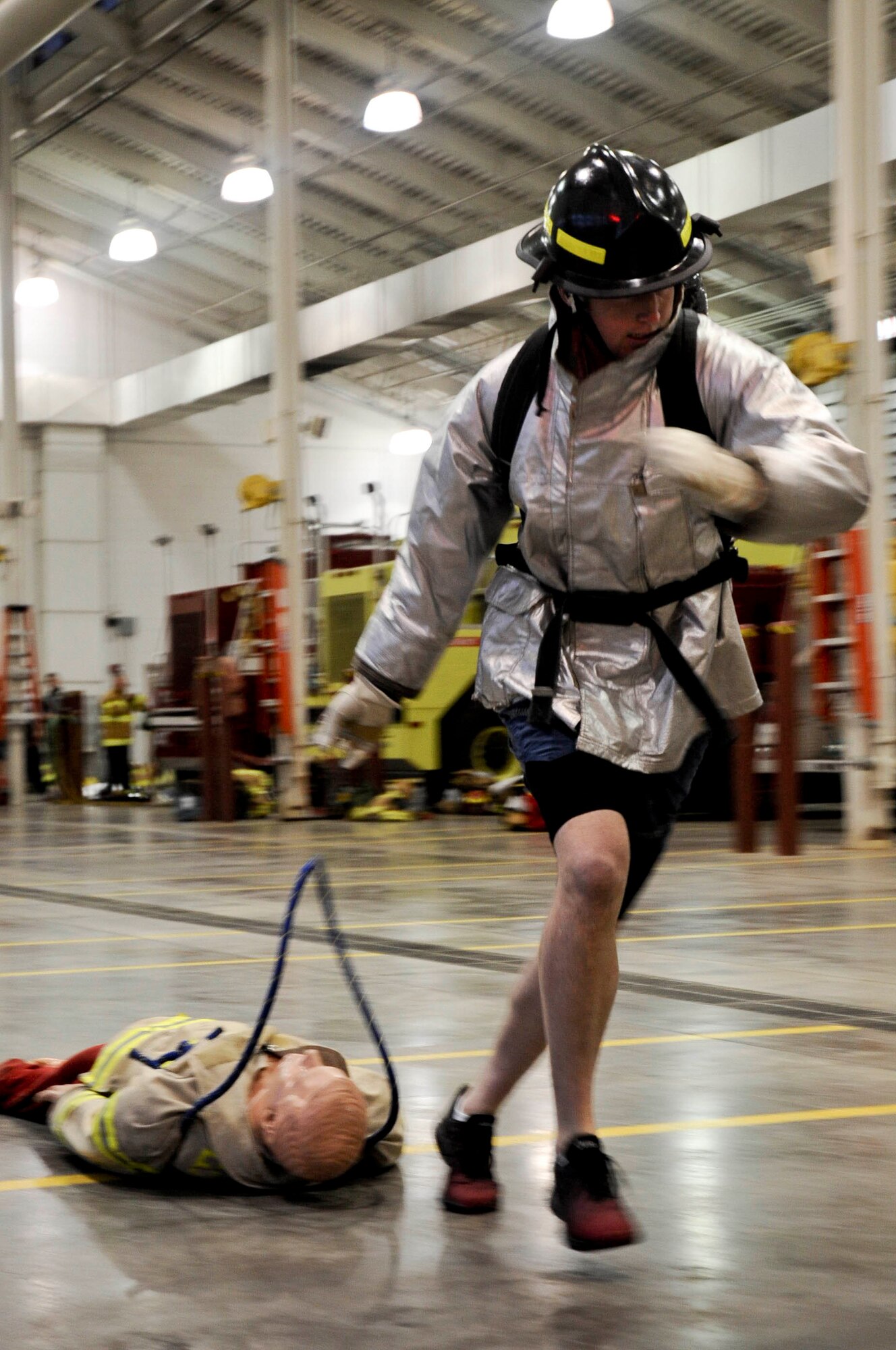 Airman 1st Class Clint Hubkey, 28th Civil Engineer Squadron heating, venting, air conditioning systems technician, drags a dummy during a Firefighter Challenge at the fire station at Ellsworth Air Force Base, S.D., Oct. 5, 2012. Participants from a variety of units from around the base had the opportunity to participate in several events including a hose drag, ladder climb and pack hoist. (U.S. Air Force photo by Airman 1st Class Anania Tekurio/Released) 