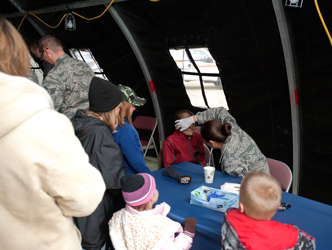 Children of McConnell Airmen get their faces painted during the Family Mobility Line Oct. 6, 2012, McConnell Air Force Base, Kan. The event, which simulated a deployment, is an annual event hosted by the Airman and Family Readiness Center. (U.S. Air Force photo/Airman 1st Class Victor J. Caputo)