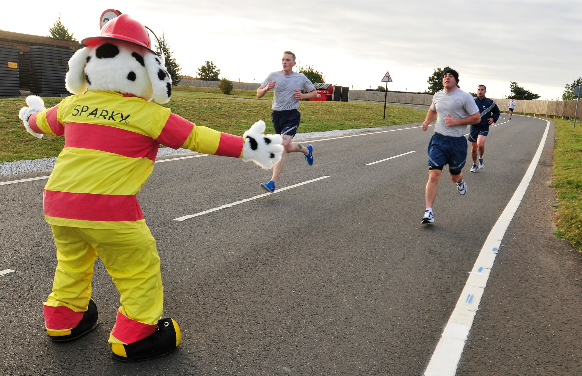 ROYAL AIR FORCE LAKENHEATH, England - Sparky cheers on Airmen as they finish a 5K for Fire Prevention Week Oct. 10, 2012. Throughout the week a series of events were coordinated by the 48th Civil Engineer Squadron firefighters to include fire extinguisher training at the commissary and a fire muster at the high school. (U.S. Air Force photo by Senior Airman Tiffany M. Grigg) 