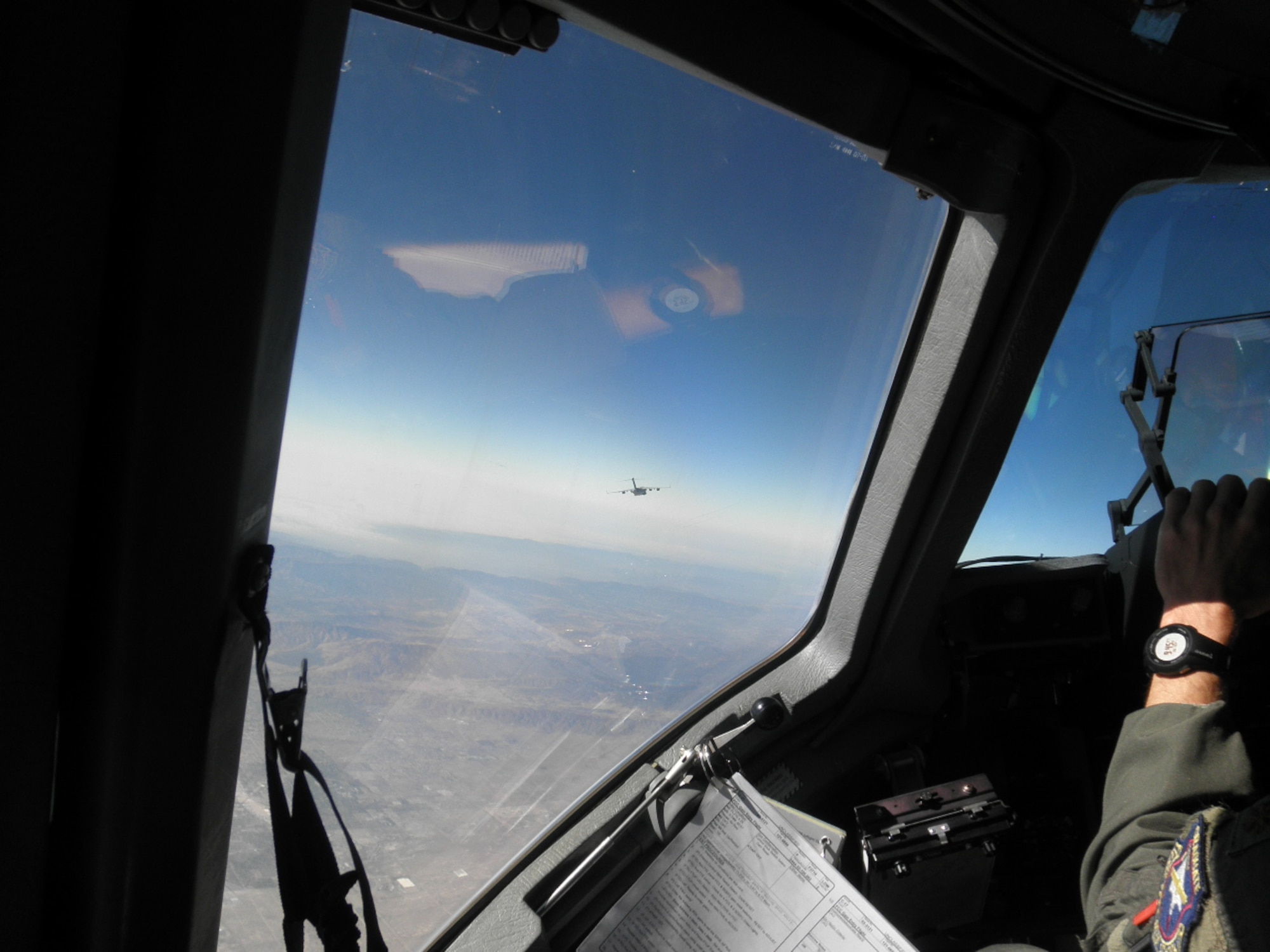 The view from a C-17 cockpit while trailing behind another C-17 during the first tests of “vortex surfing” at Edwards Air Force Base, Calif., Oct. 2, 2012. Early indications from the tests promise a reduction of fuel consumption by up to ten percent. (Courtesy photo)