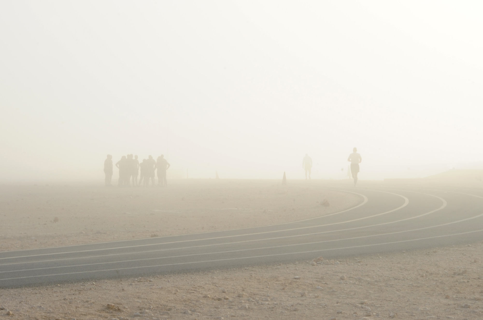 Members assigned to the 379th Air Expeditionary Wing continue their daily routine despite zero visibility during a rare foggy morning in Southwest Asia, Oct. 10, 2012. (U.S. Air Force photo/Staff Sgt. Sheila deVera)