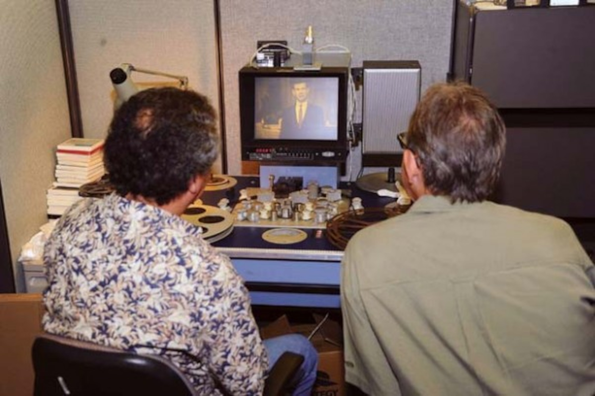 Pedro Loureiro, Ph.D. (left), Archivist at the Defense Imagery Management Operations Center (DIMOC) and Jeff Sotzing, Chief Executive Officer at Carson Entertainment Group, review a 1963 film of The Tonight Show Starring Johnny Carson that was once thought lost, but was found earlier this year. DIMOC turned over the film to Sotzing to be added to the Carson archives. (Photo by MC3 Will Gaskill)