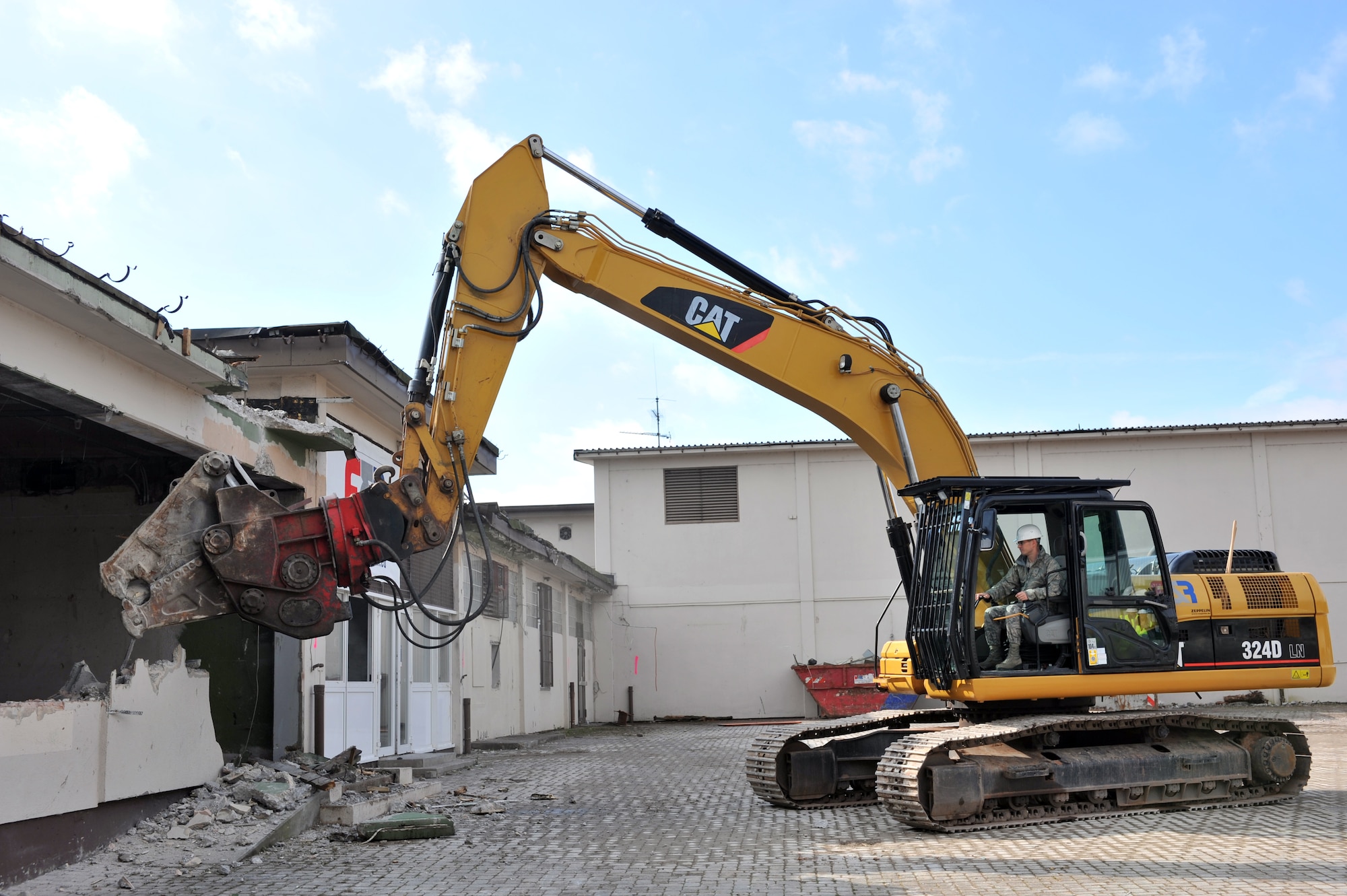 Brig. Gen. C. K. Hyde, 86th Airlift Wing commander, participates in the demolition of the old base exchange near the North Side Chapel on Ramstein Air Base, Germany, Oct. 5, 2012. The old BX was built in the 1950s, being the first shopping center on Ramstein. (U.S. Air Force photo/Senior Airman Caitlin O’Neil-McKeown)