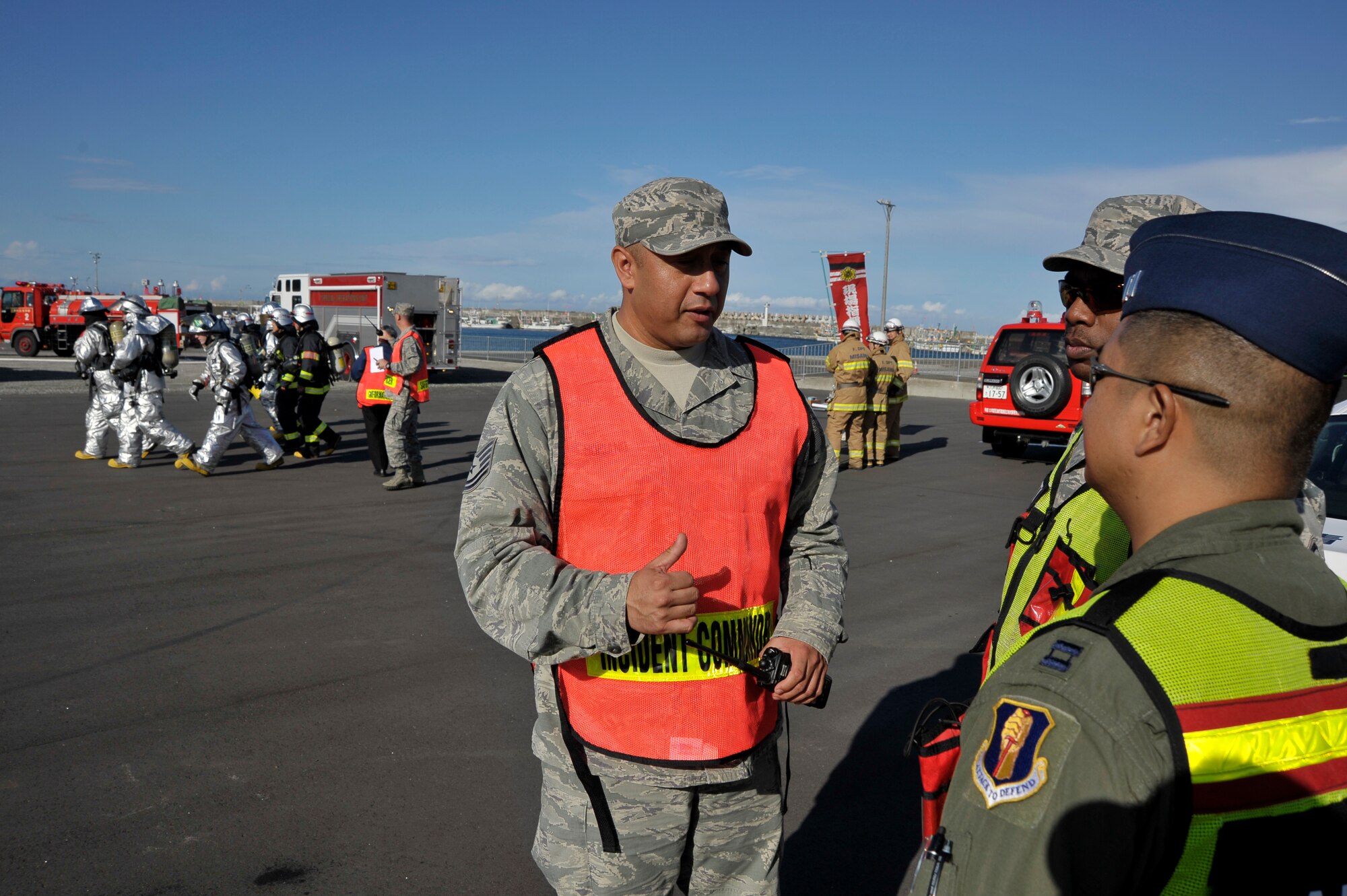 U.S. Air Force Tech. Sgt. Juan Soriano, 35th Civil Engineer Squadron firefighter, gives instructions to members of the Safety Office before allowing entry to the simulated crash site during an Emergency Management Exercise at the Misawa City Port, Misawa, Japan, Oct. 5, 2012. Soriano was the incident commander for the exercise and helped coordinate effort between U.S. and Japanese first responders once they arrived on scene. (U.S. Air Force photo by Staff Sgt. Nathan Lipscomb)