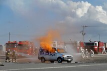Misawa City firefighters, left, and U.S. Air Force firefighters from the 35th Civil Engineer Squadron, work together to put out a simulated fire during an Emergency Management Exercise at the Misawa City Port, Misawa, Japan, Oct. 5, 2012. The EME gave U.S. and Japanese first responders a chance to showcase their ability to react rapidly and efficiently together in an emergency situation. (U.S. Air Force photo by Staff Sgt. Nathan Lipscomb)