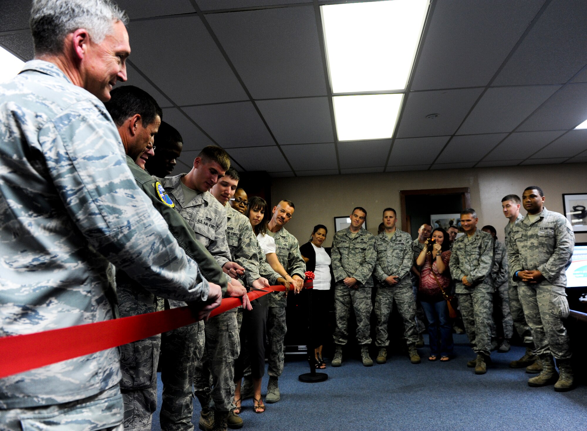 Airmen cut the ribbon marking the completion of renovations at the Wired Bean on Kadena Air Base, Japan, Oct. 10, 2012. The Wired Bean's kitchen and theater room were recently renovated to provide more alcohol-free options for Airmen. (U.S. Air Force photo/Airman 1st Class Justin Veazie)