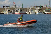 Members of the Hachinohe Coast Guard Office race to save a simulated casualty during an Emergency Management Exercise at the Misawa City Port, Misawa, Japan, Oct. 5, 2012. In a joint response, both U.S. Air Force and Japanese first responders worked together as they practiced saving lives and preventing further damage during the exercise scenario. (U.S. Air Force photo by Staff Sgt. Nathan Lipscomb)