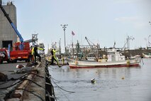 Members of the Hachinohe Coast Guard Office dive into water during an Emergency Management Exercise at the Misawa City Port, Misawa, Japan, Oct. 5, 2012. Personnel from the 35th Fighter Wing worked side-by-side with police, firefighters and Coast Guardsmen from the Misawa City area in response to a simulated aircraft accident.  (U.S. Air Force photo by Staff Sgt. Nathan Lipscomb)