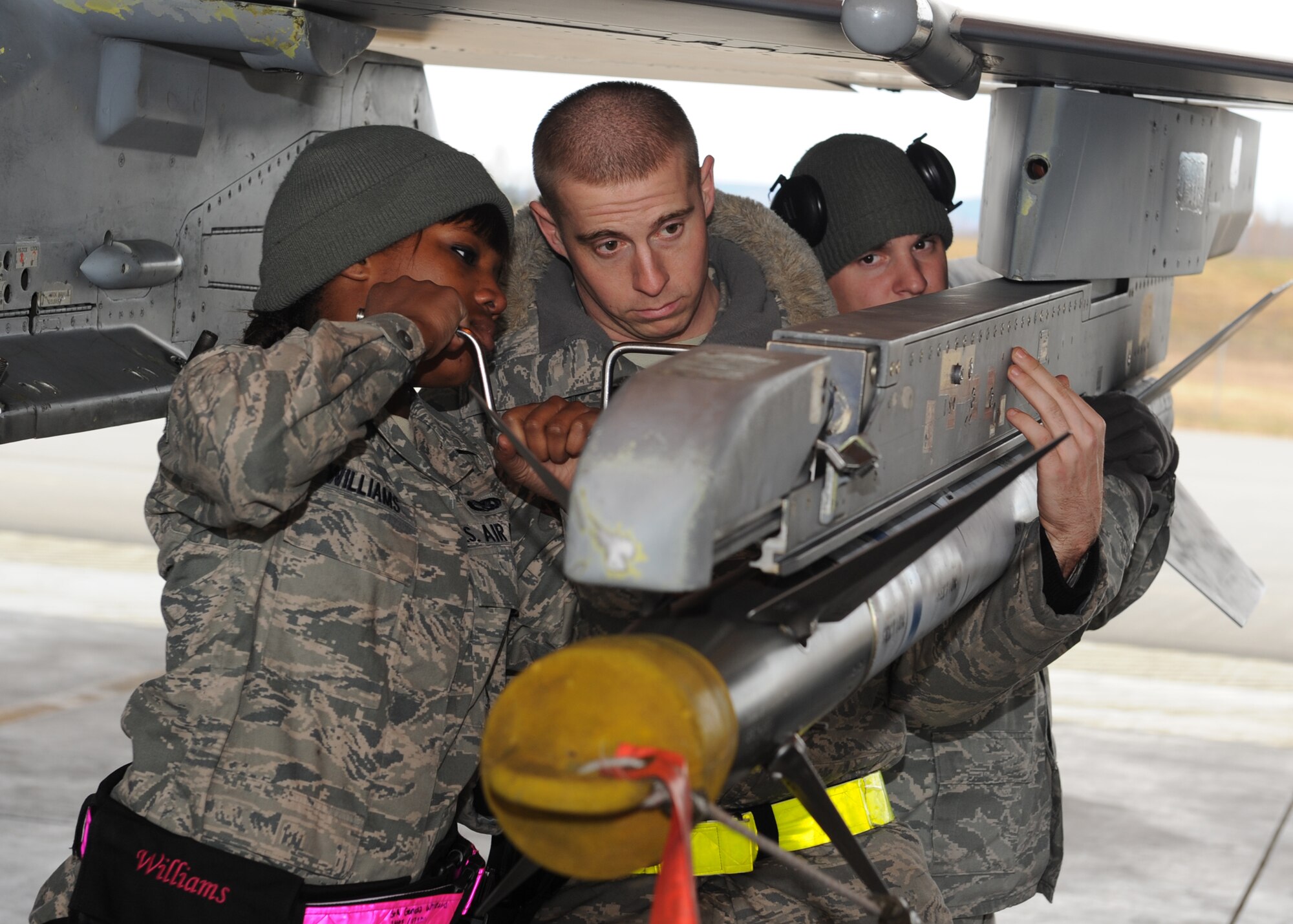 Members of the 8th Maintenance Operations Squadron remove a missile from an F-16 Fighting Falcon with the 35th Fighter Squadron, Kunsan Air Base, Republic of Korea, during Red Flag-Alaska on Eielson Air Force Base, Alaska, Oct. 5, 2012. Personnel from Kunsan participated in the Distant Frontier and Red Flag-Alaska exercises designed to test the combat and mission readiness of military personnel, equipment and aircraft. (U.S. Air Force photo/Staff Sgt. Jonathan Fowler)