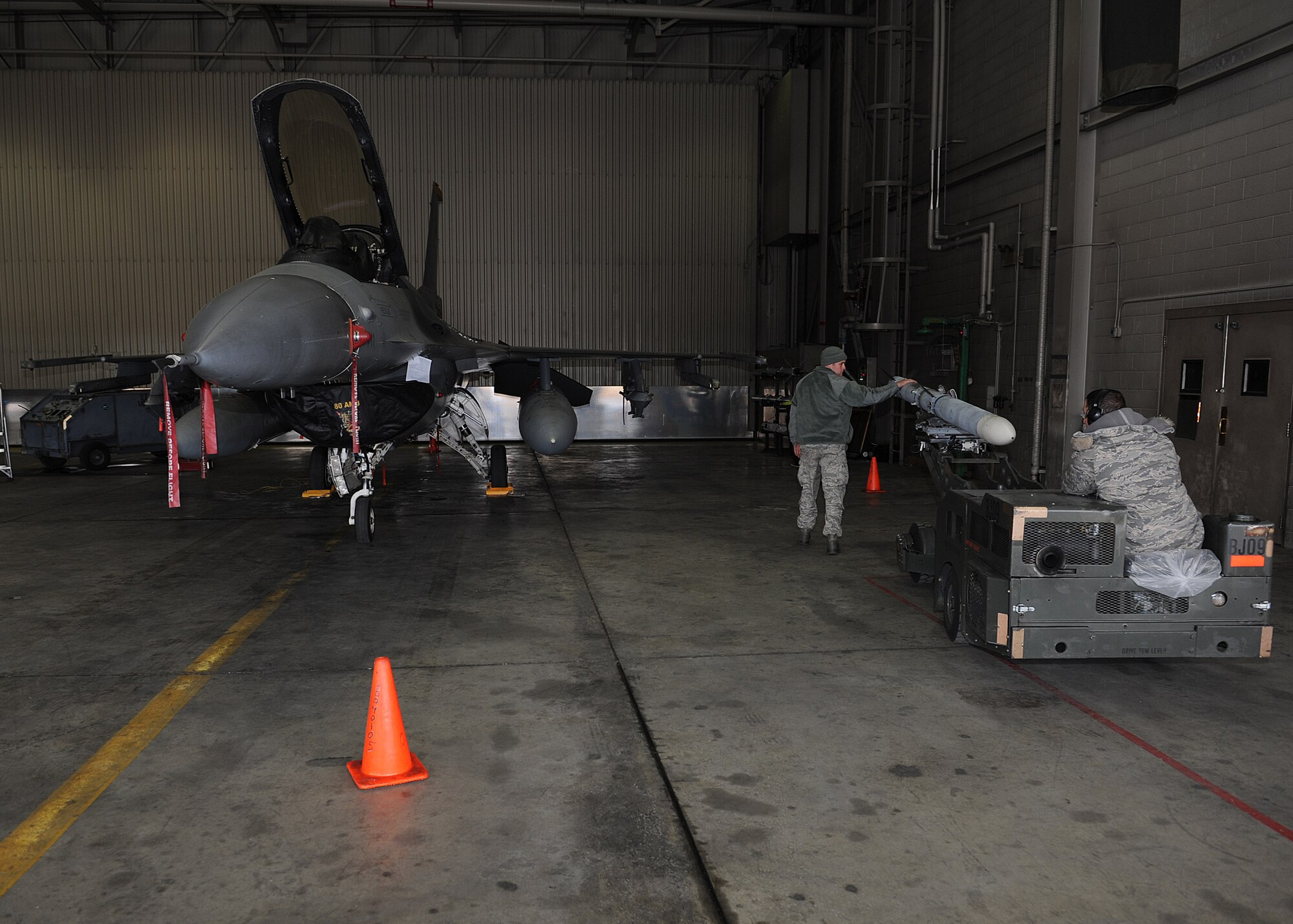 Members of the 8th Aircraft Maintenance Squadron, Kunsan Air Base, Republic of Korea, move a missile between training missions during Red Flag-Alaska on Eielson Air Force Base, Alaska, Oct. 5, 2012. Personnel from Kunsan participated in Distant Frontier and Red Flag, exercises designed to test the combat and mission readiness of military personnel, equipment and aircraft. (U.S. Air Force photo/Staff Sgt. Jonathan Fowler)