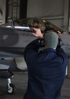 Senior Airman Samuel Strong, 8th Aircraft Maintenance Squadron crew chief, Kunsan Air Base, Republic of Korea, guides an F-16 Fighting Falcon in a hangar during Red Flag-Alaska on Eielson Air Force Base, Alaska, Oct. 5, 2012. This was the beginning of Red Flag, an exercise assessing the capabilities of F-16s from around the world. (U.S. Air Force photo/Staff Sgt. Jonathan Fowler)