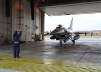Senior Airman Javier Zepeda, 8th Aircraft Maintenance Squadron crew chief, Kunsan Air Base, Republic of Korea, guides an F-16 Fighting Falcon with the 35th Fighter Squadron, Kunsan, during Red Flag-Alaska on Eielson Air Force Base, Alaska, Oct. 5, 2012. More than 150 personnel from Kunsan participated in Distant Frontier and Red Flag, exercises designed to test the combat and mission readiness of military personnel, equipment and aircraft. (U.S. Air Force photo/Staff Sgt. Jonathan Fowler)