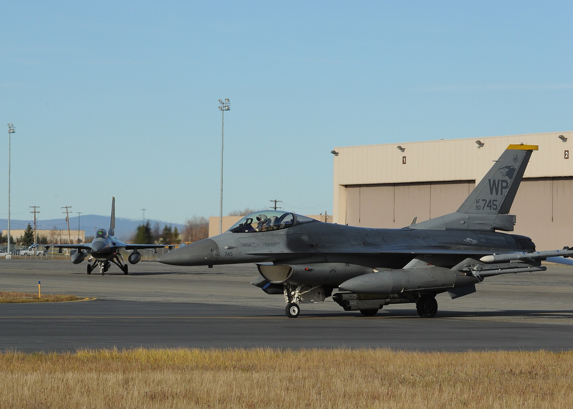 Two F-16 Fighting Falcons with the 35th Fighter Squadron, Kunsan Air Base, Republic of Korea, taxi to the runway during Distant Frontier on Eielson Air Force Base, Alaska, Oct. 3, 2012. Aircraft and military members from Kunsan came to Eielson to participate in Distant Frontier and Red Flag-Alaska, both of which assess the mission and combat capabilities of numerous Air Force squadrons. (U.S. Air Force photo/Staff Sgt. Jonathan Fowler)
