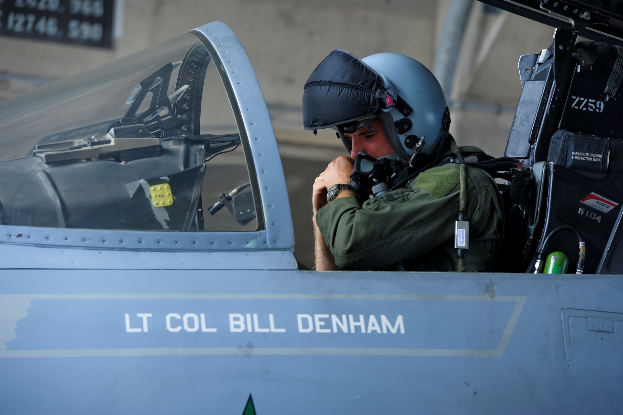 U.S. Air Force Capt. Dustin Johnson, 67th Fighter Squadron F-15 Eagle pilot, puts on his helmet during a preflight check on Kadena Air Base, Japan, Oct. 10, 2012. The F-15's superior maneuverability and acceleration are achieved through high engine thrust-to-weight ratio and low wing loading. (U.S. Air Force photo/Airman 1st Class Justin Veazie)