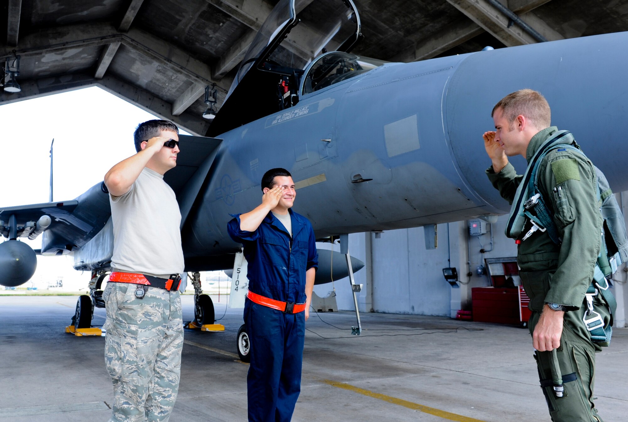 U.S. Air Force Staff Sgt. Jonathan Allison, 67th Aircraft Maintenance Unit crew chief, and Airman 1st Class Eric Gandall, 67th AMU aircraft armament technician, salute Capt. Dustin Johnson, 67th Fighter Squadron F-15 Eagle pilot on Kadena Air Base, Japan, Oct. 10, 2012. The 67th FS is one of the two F-15 Eagle squadrons in the Asia-Western Pacific area of operations. (U.S. Air Force photo/Airman 1st Class Justin Veazie)