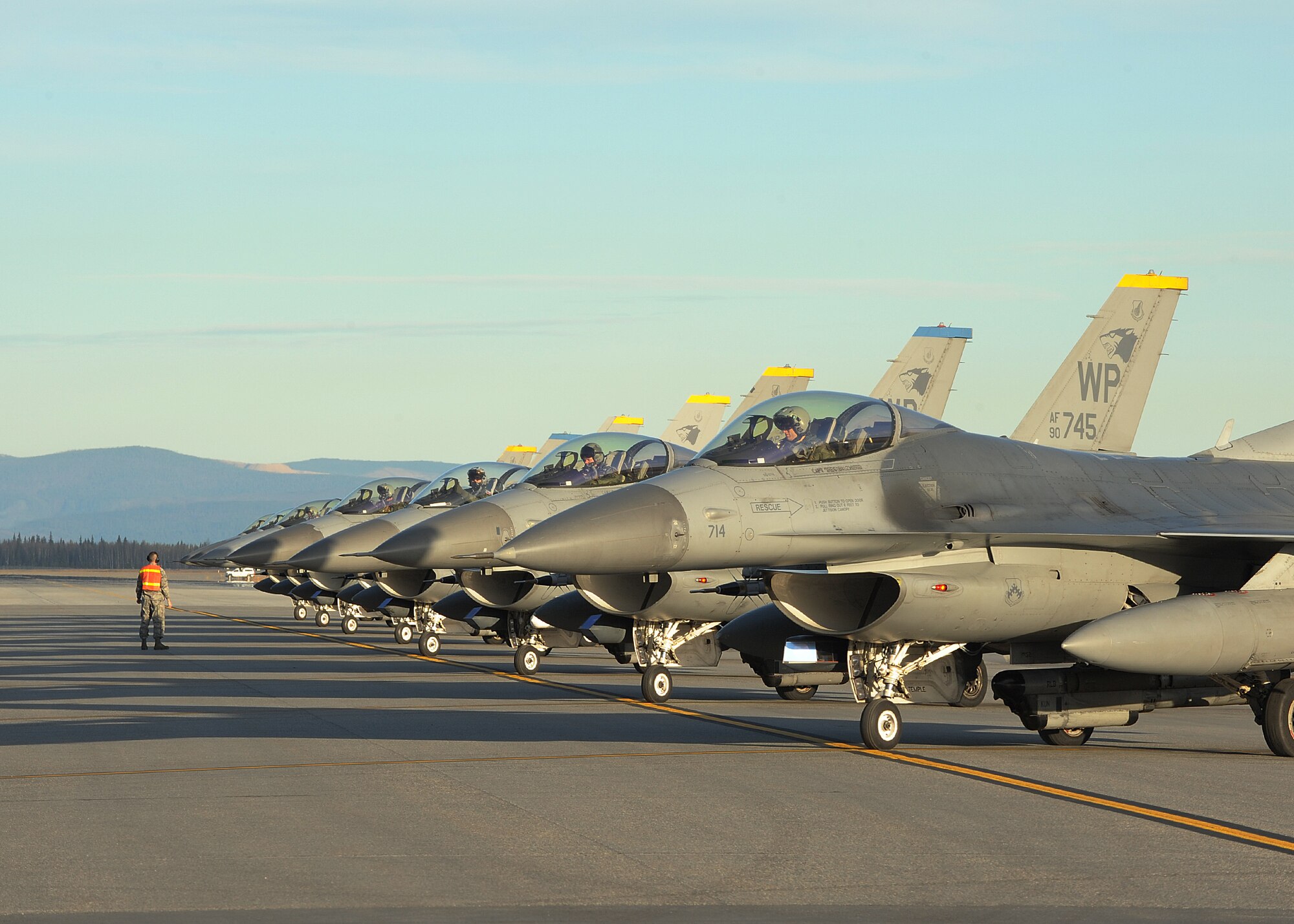 Several F-16 Fighting Falcons with the 35th Fighter Squadron, Kunsan Air Base, Republic of Korea, wait to take off during Distant Frontier on Eielson Air Force Base, Alaska, Oct. 3, 2012. Fourteen aircraft from the 8th FW participated in Distant Frontier and Red Flag-Alaska, two exercises featuring simulated combat scenarios to test the combat and mission capabilities and effectiveness of participating squadrons. (U.S. Air Force photo/Staff Sgt. Jonathan Fowler)