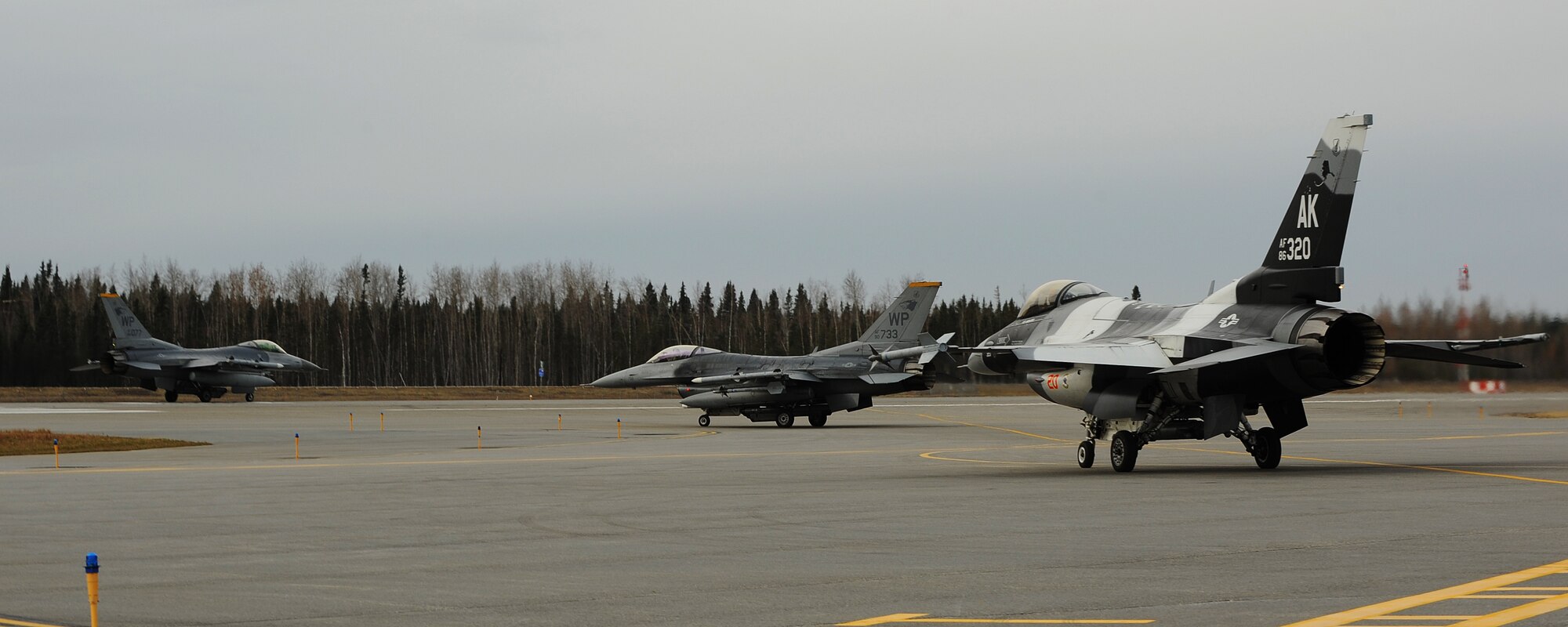 Two F-16 Fighting Falcons with the 35th Fighter Squadron at Kunsan Air Base, Republic of Korea, and an F-16 with the 18th Aggressor Squadron prepare for takeoff during Distant Frontier on Eielson Air Force Base, Alaska, Oct. 2, 2012. Distant Frontier is an exercise testing the mission assets and capabilities of various squadrons in preparation for Red Flag-Alaska. (U.S. Air Force photo/Staff Sgt. Jonathan Fowler)