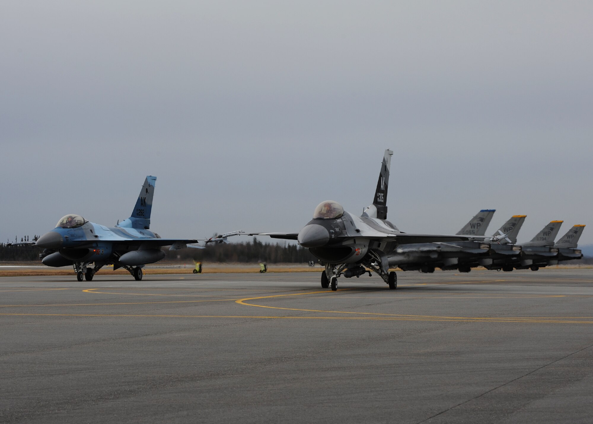 Two F-16 Fighting Falcons with the 18th Aggressor Squadron prepare to take off while F-16s from the 35th Fighter Squadron at Kunsan Air Base, Republic of Korea, wait behind them during Distant Frontier on Eielson Air Force Base, Alaska, Oct. 2, 2012. The aircraft are participating in Distant Frontier and Red Flag-Alaska, which feature simulated combat scenarios with the 18th AS acting as the “enemy” for Kunsan aircraft. (U.S. Air Force photo/Staff Sgt. Jonathan Fowler)