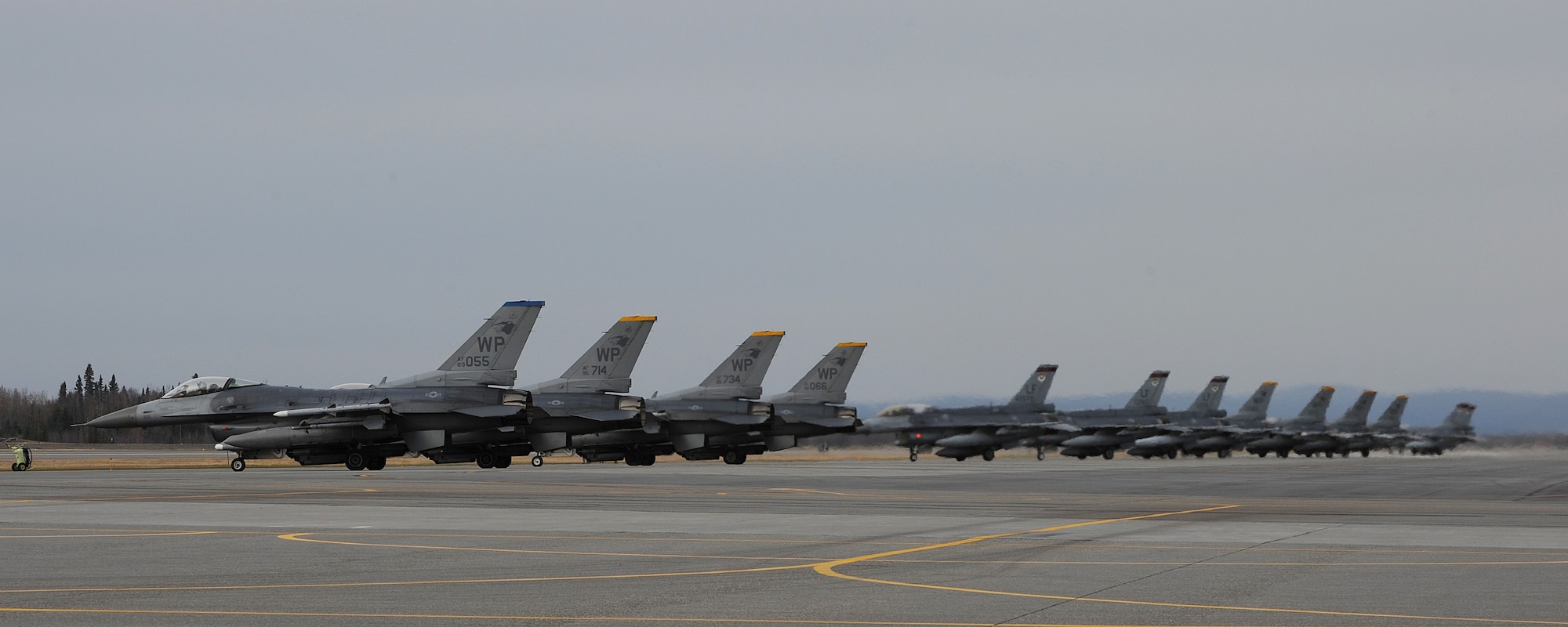Numerous F-16 Fighting Falcons from the 8th Fighter Wing at Kunsan Air Base, Republic of Korea, and other squadrons wait in line before taking off from Eielson Air Force Base, Alaska, Oct. 2, 2012. Fourteen aircraft from the 8th FW participated in Distant Frontier and Red Flag-Alaska, two exercises featuring simulated combat scenarios to test the combat and mission capabilities and effectiveness of participating squadrons. (U.S. Air Force photo/Staff Sgt. Jonathan Fowler)