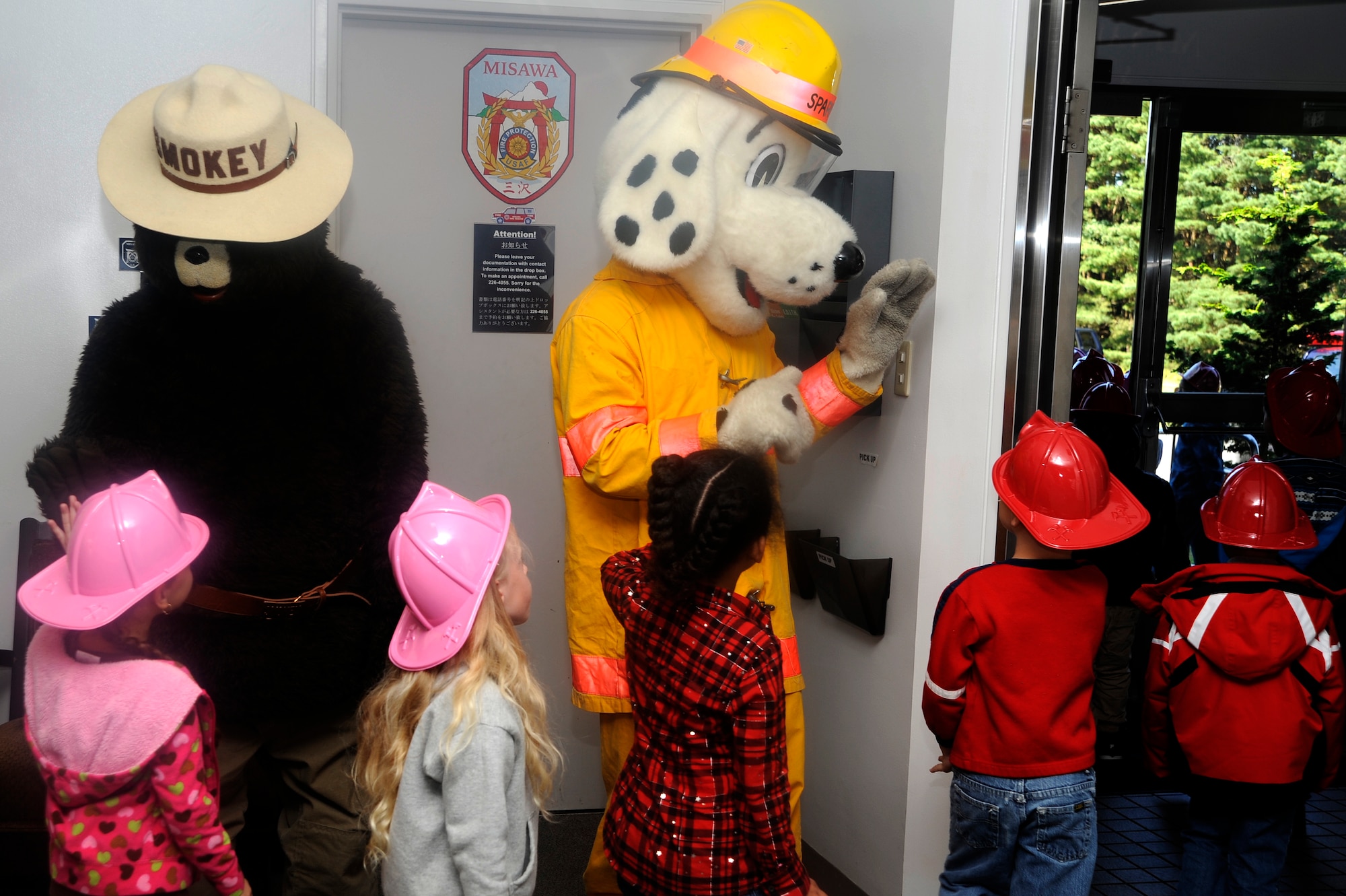 Smokey the Bear and Sparky the Fire Dog say bye to first grade students from Sollars Elementary School after their tour of Fire Station 1 at Misawa Air Base, Japan, Oct. 9, 2012. Fire prevention week was established to commemorate the Great Chicago Fire of 1871 that killed more than 250 people, left 100,000 homeless, destroyed more than 17,400 structures and burned more than 2,000 acres. (U.S. Air Force photo by Tech. Sgt. Marie Brown)