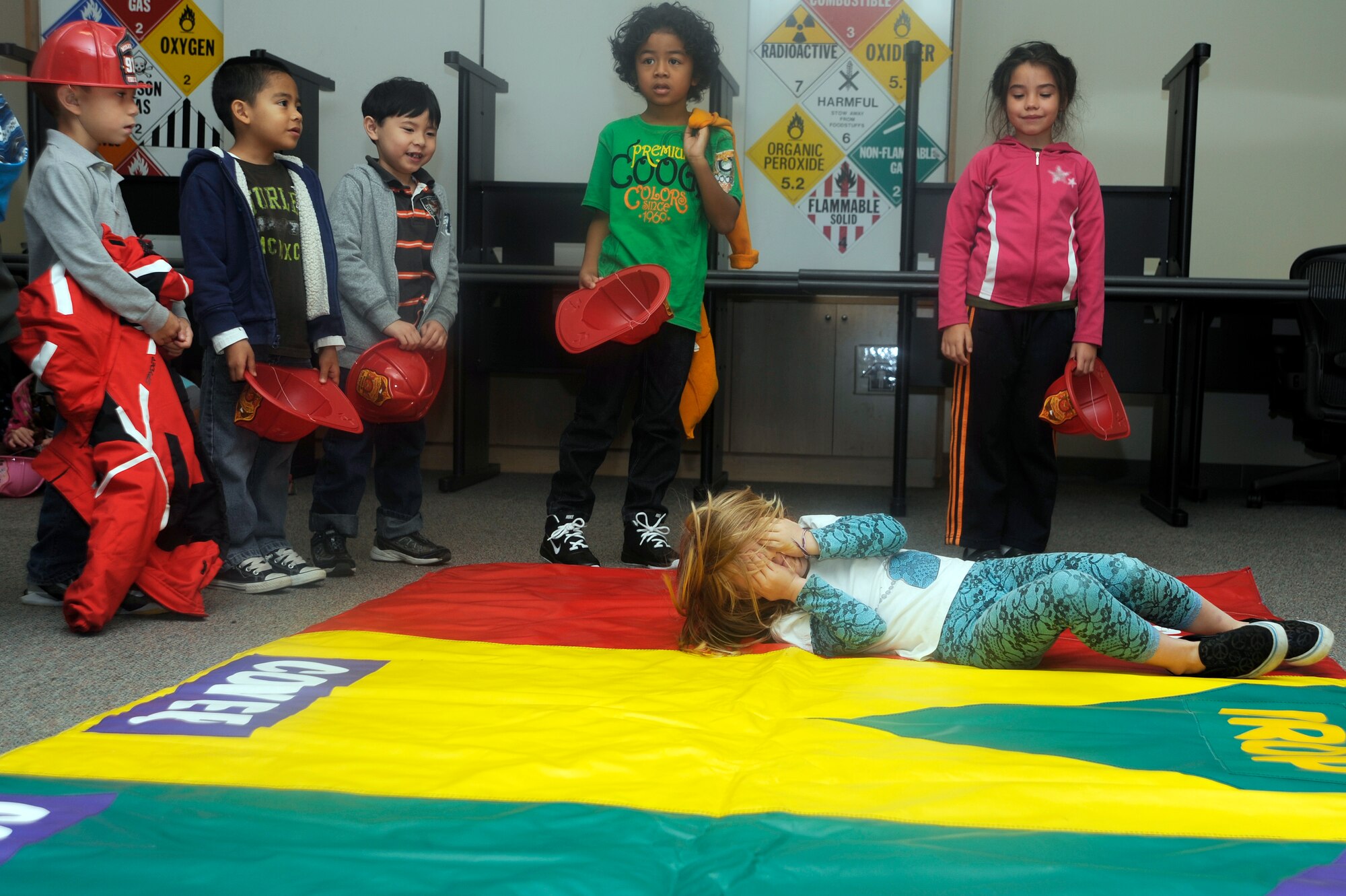 The daughter of U.S. Air Force Staff Sgt. Stephen Ocenosak, 35th Fighter Wing public affairs, demonstrates how to stop, drop and roll during a visit to Fire Station 1 at Misawa Air Base, Japan, Oct. 9, 2012. Members of the 35th Civil Engineer Squadron hosted students from Sollars Elementary School to teach them about fire safety. This week is all about fire prevention and is set aside to provide the community with sound fire prevention, safety knowledge and promotion of a fire-safe lifestyle. (U.S. Air Force photo by Tech. Sgt. Marie Brown)