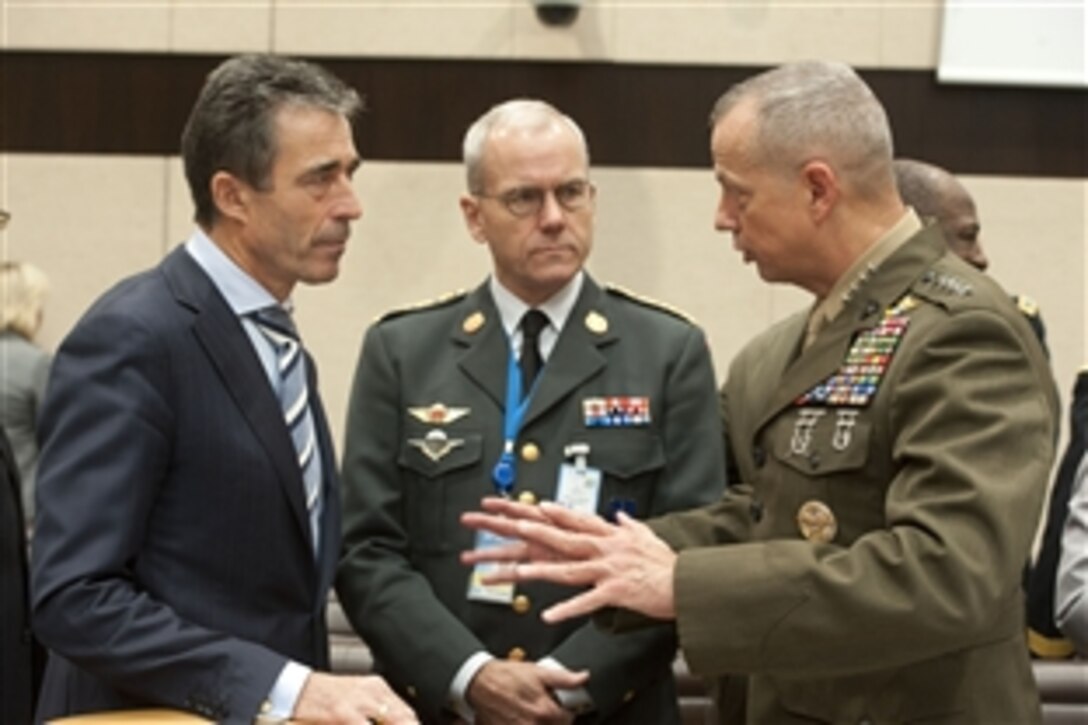 Marine Corps Gen. John R. Allen, right, the commander of the International Security Assistance Force and U.S. forces in Afghanistan, speaks with NATO Secretary General Anders Fogh Rasmussen, left, before a conference of NATO defense ministers in Brussels, Oct. 10, 2012. 
