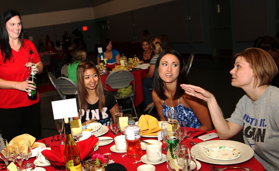 Natasha Harth, mentor, L.I.N.K.S, discusses appropriate behavior for the Marine Corps Birthday Ball Saturday with Combat Center wives and girlfriends during the first Belle of the Ball event at the Community Center on base. The event taught formal affair etiquette to wives and girlfriends who may have never been exposed to black tie events. It also familiarized them with the Marine Corps customs and history regarding the Birthday Ball.