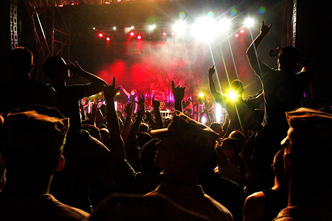 Combat Center patrons raise their hands to cheer on Hinder during the Sounds of Freedom 2012 concert on Lance Cpl. Torrey L. Gray Field Sept. 29, 2012. Hundreds of Marines, sailors and family members watched Hinder and Theory of a Deadman perform.