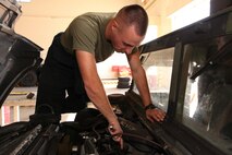 Cpl. Jesse L. Henkel repairs a tactical vehicle at Camp Kinser Oct. 1. Henkel helps maintain III Marine Expeditionary Force’s mission readiness by conducting intermediate maintenance on III MEF vehicles. Henkel is an automotive maintenance technician with 3rd Maintenance Battalion, Combat Logistics Regiment 35, 3rd Marine Logistics Group, III MEF.