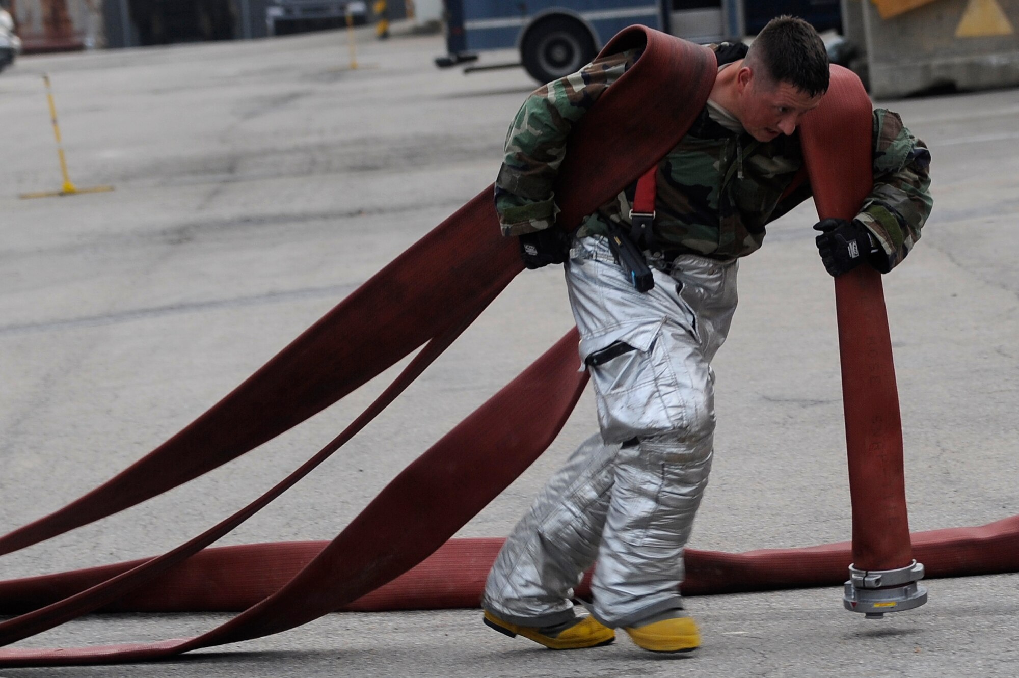 Staff Sgt. Jared Lott,8th Civil Engineer Squadron firefighter, puts away fire hoses at Kunsan Air Base, Republic of Korea, Sept. 27, 2012 during an exercise. The firefighters responded to a simulated fire from a mortar strike. (U.S. Air Force photo/Senior Airman Marcus Morris)