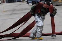 Staff Sgt. Jared Lott,8th Civil Engineer Squadron firefighter, puts away fire hoses at Kunsan Air Base, Republic of Korea, Sept. 27, 2012 during an exercise. The firefighters responded to a simulated fire from a mortar strike. (U.S. Air Force photo/Senior Airman Marcus Morris)