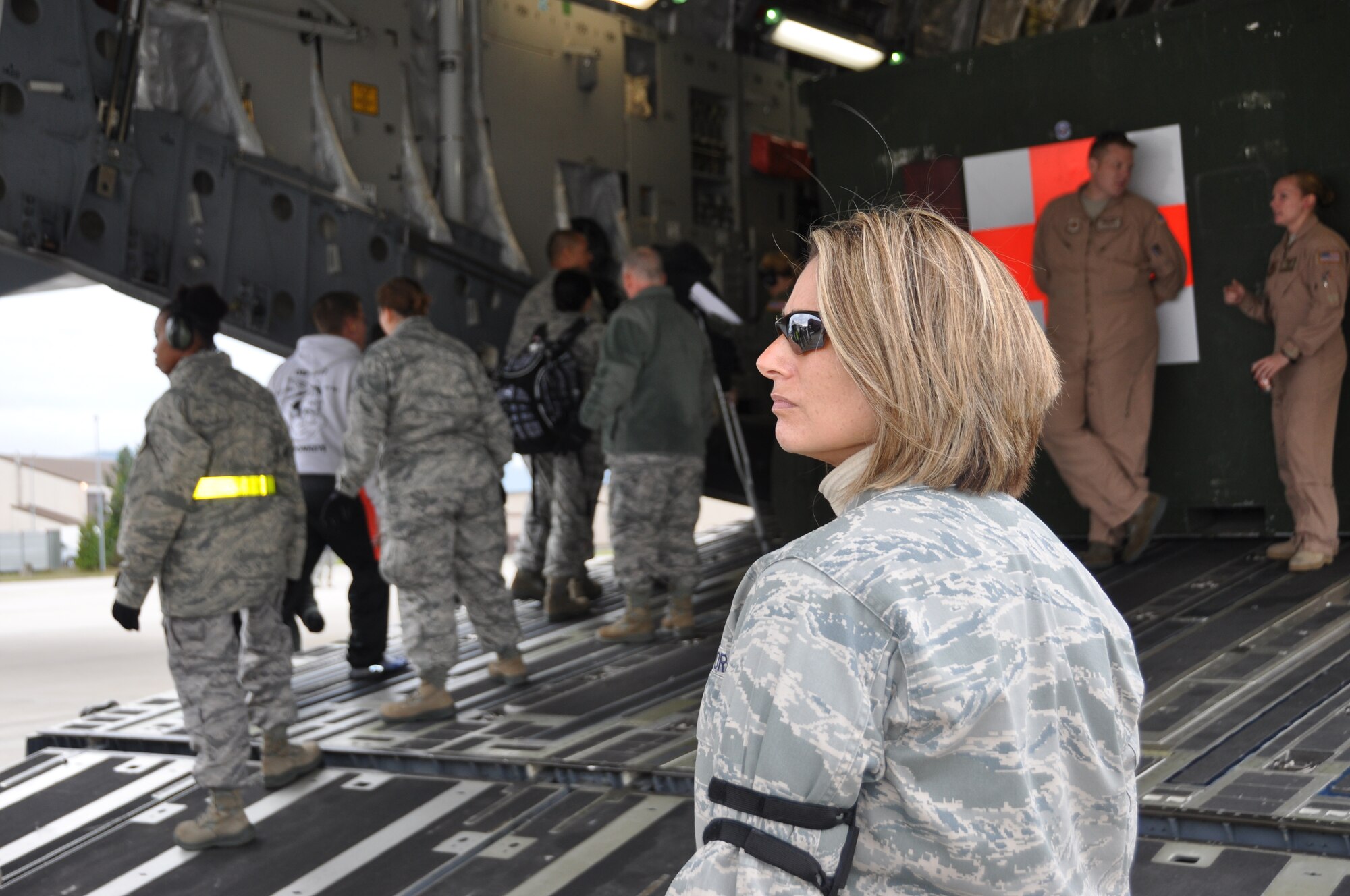 Maj. Maria Coppola, a Contingency Aeromedical Staging Facility director at Ramstein Air Base, Germany, monitors ambulatory patient loading on Ramstein's flightline prior to their departure for continued care in the United States. The Air Force's Strategic Transitory Care process ensures wounded warriors are kept safe and receive consistent care throughout the journey from Afghanistan through Germany to the United States. (U.S. Air Force photo/TSgt Shawn David McCowan)