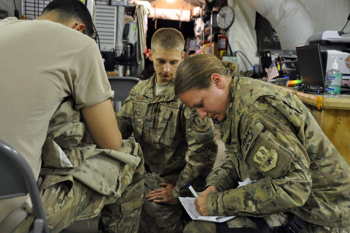 1st Lt. Rachel Hinson, a Registered Nurse at Bagram’s Contingency Aeromedical Staging Facility, and SrA Christopher Foster, a patient care technician, check a CASF patient's vital signs and update his records prior to his departure for Ramstein Air Base, Germany. The Air Force's Strategic Transitory Care process ensures wounded warriors are kept safe and receive consistent care throughout the journey from Afghanistan through Germany to the United States. (U.S. Air Force photo/TSgt Shawn David McCowan)