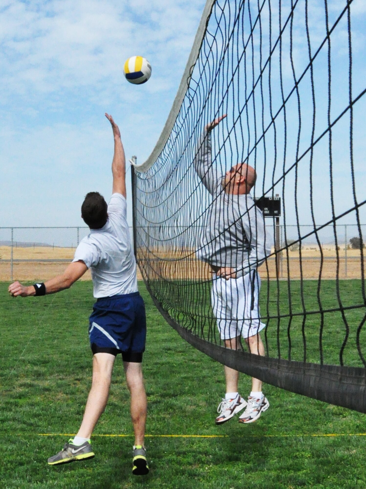 A 9th Civil Engineer Squadron team member (left) goes for a block against the 9th Maintenance Operations Squadron team during the volleyball portion of Beale Air Force Base's annual sports day Oct. 5. (U.S. Air Force photo by Tech. Sgt. Eric Petosky/Released) 