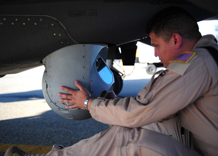 A sensor operator adjusts the West Cam MX-15 camera on the bottom of the Air Force MC-12W Liberty intelligence, surveillance, and reconnaissance aircraft on the Beale Air Force Base flight line Oct. 9, 2012. The MC-12W???s capabilities support all aspects of the worldwide Air Force irregular warfare mission, including counter-insurgency, foreign internal defense and partnership capacity building. (U.S. Air Force photo by Senior Airman Shawn Nickel/Released)