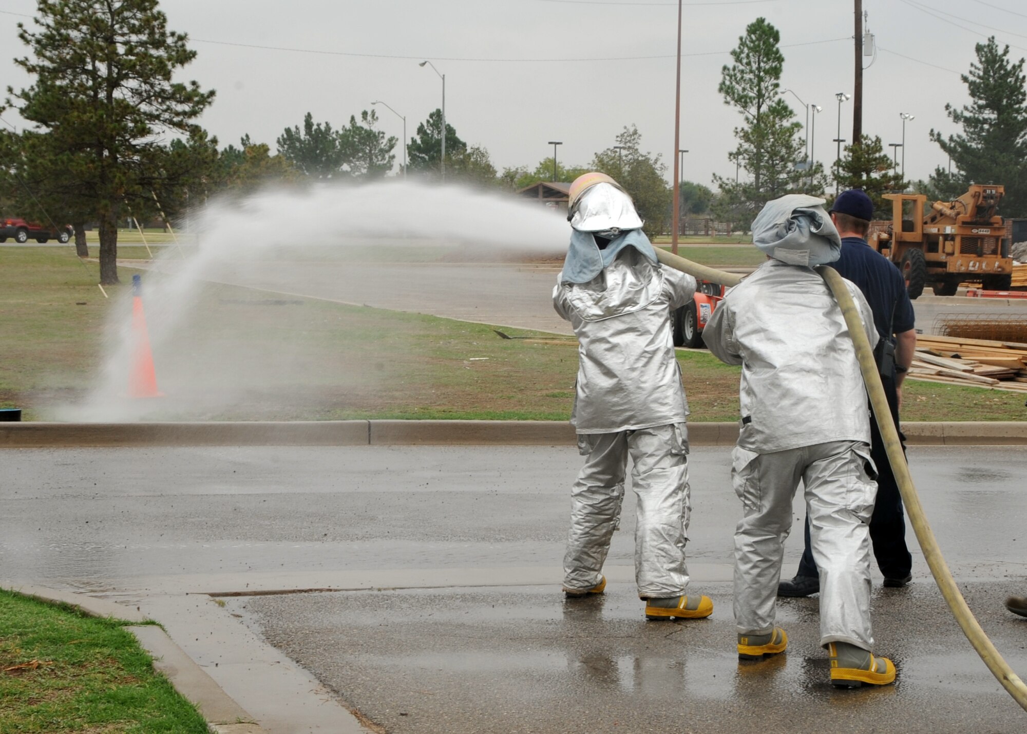 ALTUS AIR FORCE BASE, Okla. – Lt. Col. Trent Falon, 97th Force Support Squadron commander, and Master Sgt. Christopher Johnson, 97th FSS first sergeant, use a fire hose to knock down a target during the Squadron Commander’s Challenge as part of Fire Prevention Week, Oct. 11, 2012. Falon and Johnson participated in an obstacle course to get a glimpse at some of the challenges firefighters go through in emergency situations. Fire Prevention Week is held annually to promote fire safety and prevention through activities and demonstrations held throughout the base. (U.S. Air Force photo by Airman 1st Class Levin Boland / Released) 