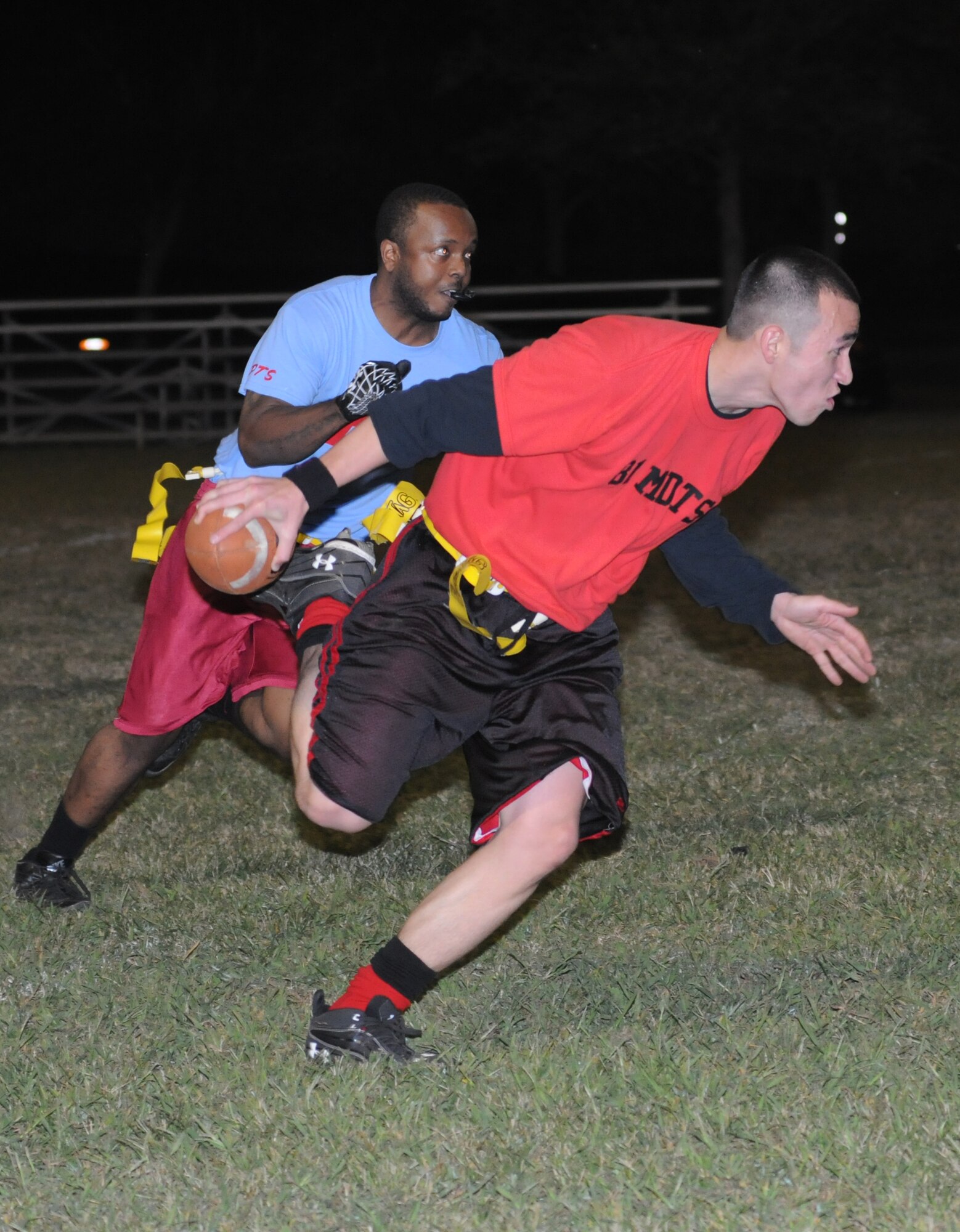 Jay Williams, 81st Inpatient Operation Squadron, closes in on quarterback, Richard Perez, 81st Diagnostic and Therapeutics Squadron, as he makes a run for the end zone during an intramural flag football game Oct. 9, 2012, at Keesler Air Force Base, Miss.  81st MDTS defeated the 81st IPTS, 31-12.  (U.S. Air Force photo by Kemberly Groue)