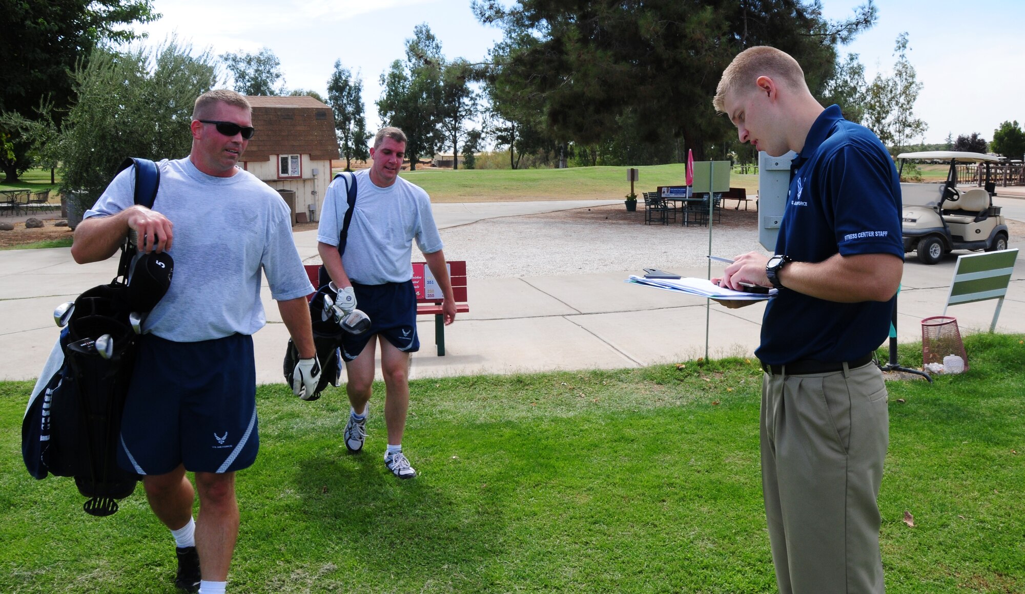 Members of Team Beale cross the finish line during the speed golf portion of the annual base sports day at Coyote Run Golf course, Beale Air Force Base Calif. Oct. 5, 2012. Each player could only carry a maximum of six clubs throughout the challenge and had to rotate shots with their partner. (U.S. Air Force photo by Senior Airman Allen Pollard)