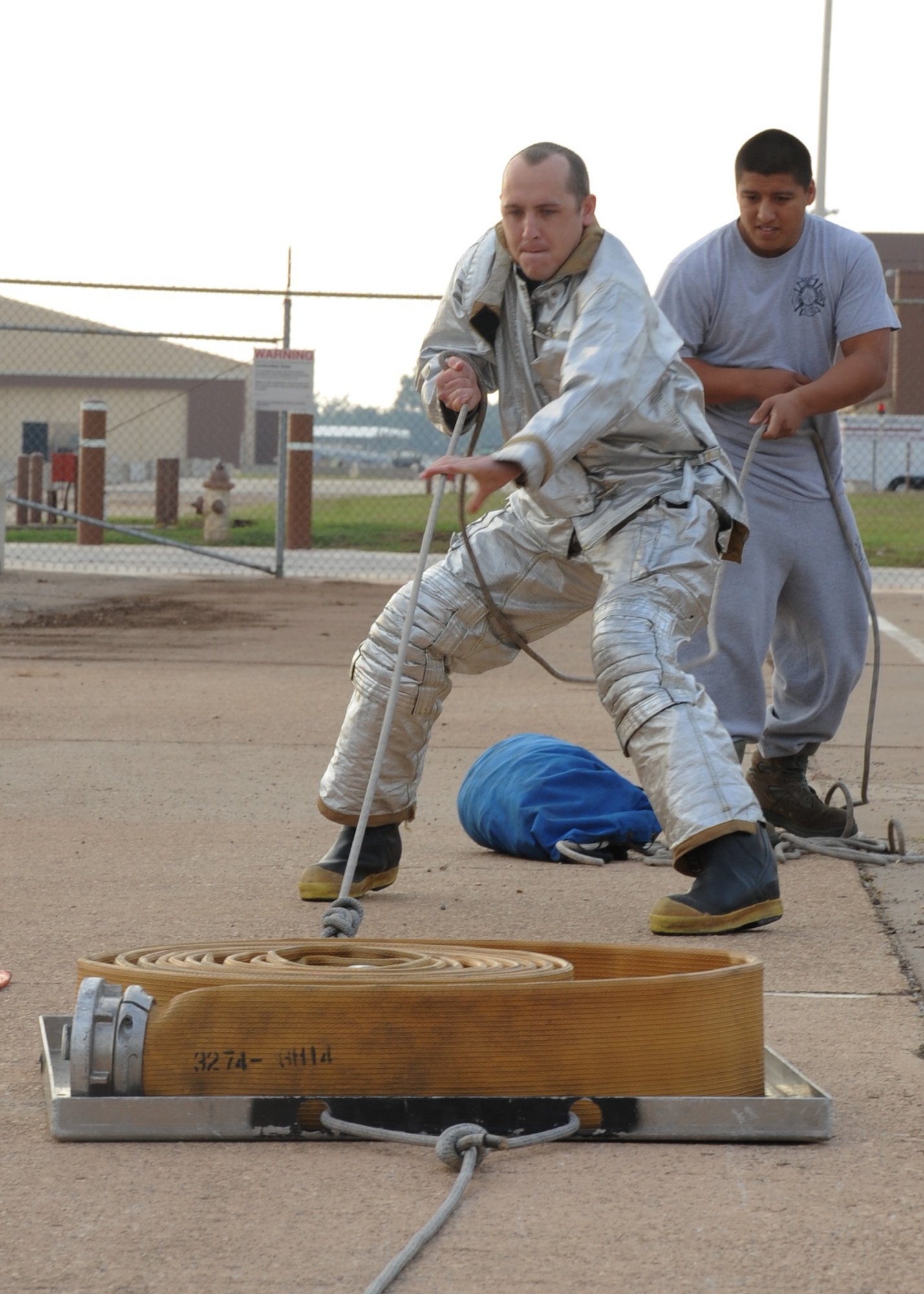 Senior Airman Parker Hale, 608th Air Operations Center air tasking order production, performs a hose hoist during the  2nd Bomb Wing Annual Fire Muster Challenge on Barksdale Air Force Base, La., Oct. 11. Six teams competed in the timed challenge which was held as part of Fire Prevention Week. (U.S. Air Force photo/Senior Airman Sean Martin)(RELEASED)