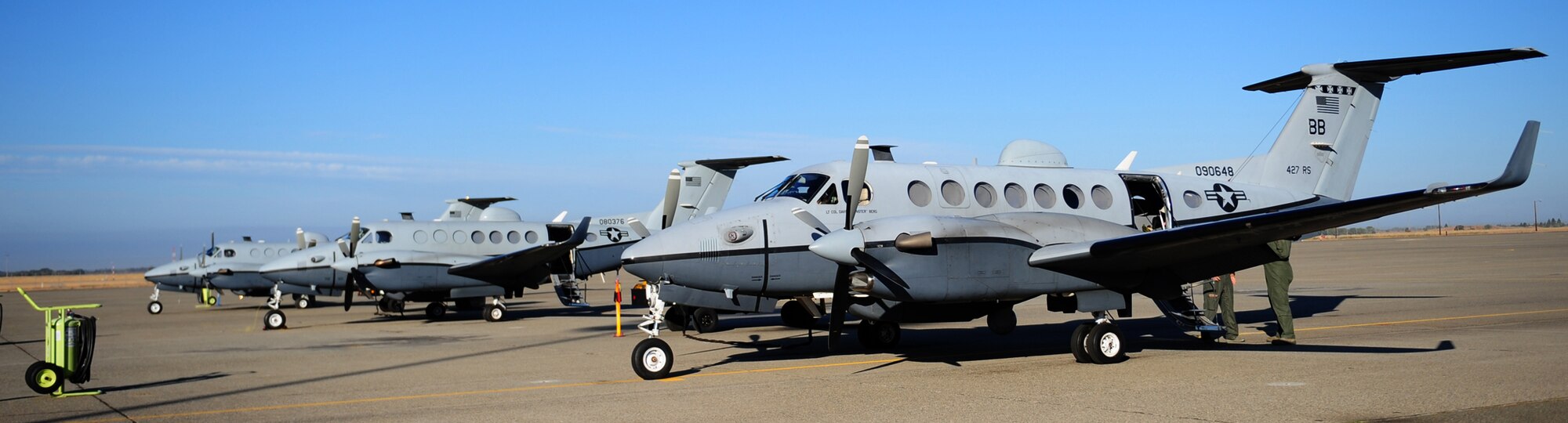 Three Air Force MC-12W Liberty intelligence, surveillance, and reconnaissance aircraft are loaded with crew and equipment in preparation for a training flight at Beale Air Force Base Oct. 9, 2012. The aircrew consists of two pilots, a sensor operator and a tactical systems operator. (U.S. Air Force photo by Senior Airman Shawn Nickel/Released)