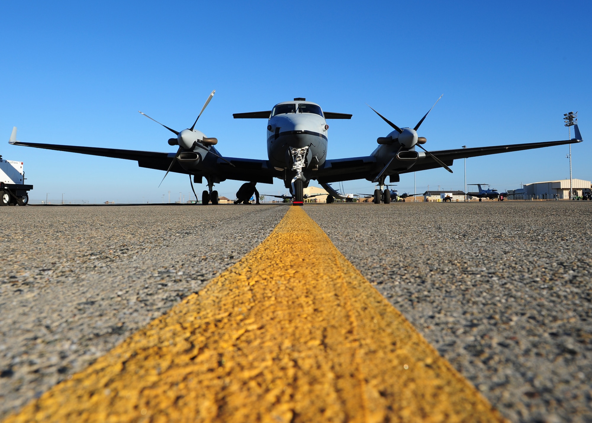 A pilot is shadowed by the wing of an Air Force MC-12W Liberty intelligence, surveillance, and reconnaissance aircraft on the Beale Air Force Base flight line Oct. 9, 2012. The MC-12W is a medium altitude, twin-engine, turboprop aircraft loaded with high tech optical and sensor equipment. (U.S. Air Force photo by Senior Airman Shawn Nickel/Released)