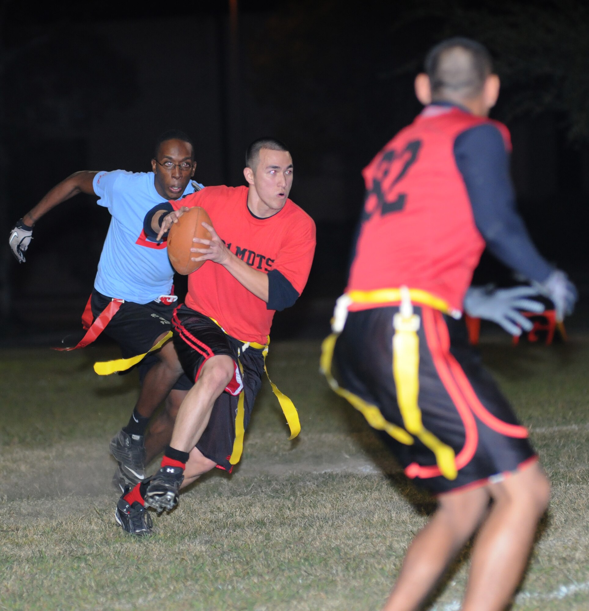Marquez Barr, 81st Inpatient Operation Squadron, hustles after quarterback, Richard Perez, 81st Diagnostic and Therapeutics Squadron, as he looks for a teammate to pass the ball to with  Steven Guerrero, 81st MDTS, gets set to make the catch during an intramural flag football game Oct. 9, 2012, at Keesler Air Force Base, Miss.  81st MDTS defeated the 81st IPTS, 31-12.  (U.S. Air Force photo by Kemberly Groue)