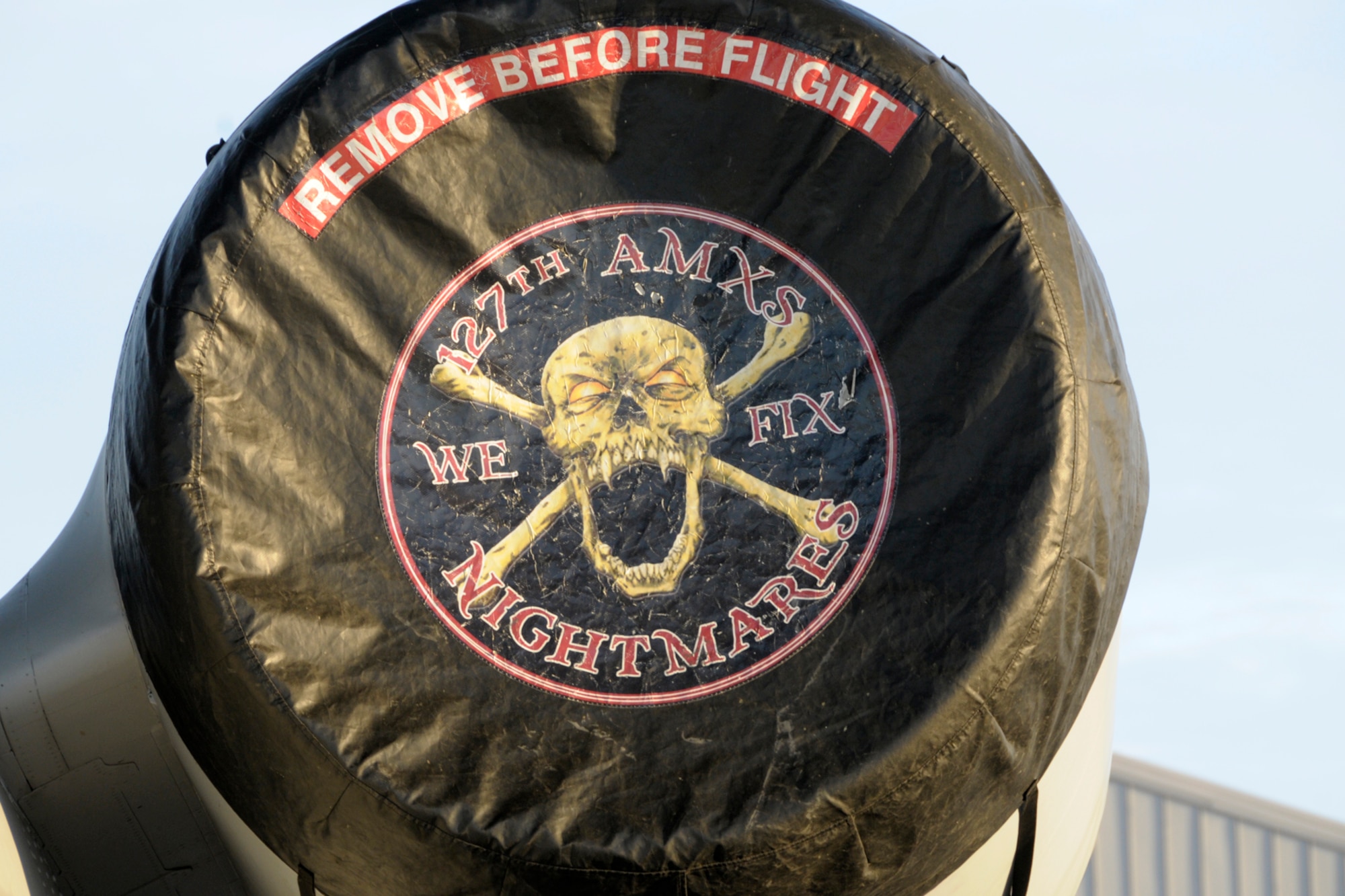 The logo of the 127th Aircraft Maintenance Squadron is seen on an engine cover of an A-10 Thunderbolt II at Selfridge Air National Guard Base, Mich. The logo features an open-jawed skeleton head over crossbones with the motto “We Fix Nightmares.” The 127th AMXS is part of the 127th Maintenance Group, which maintains the fleet of A-10s at Selfridge. The engine cover is removed prior to engine start-up and the flight of the aircraft. (Air National Guard photo by Brittani Baisden)
