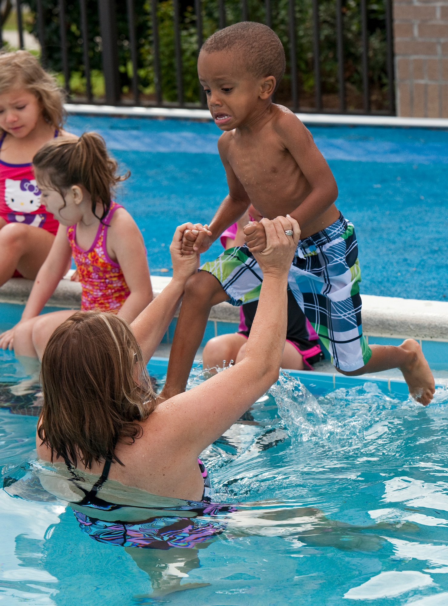 Elijah Valley, son of U.S. Air Force Tech. Sgt. Leisha Valley from the 361st Intelligence Reconnaissance Surveillance Group, jumps into the water with help from Katherine Moore, assistant school age coordinator at the Hurlburt Field Youth Center, during swim lessons on Hurlburt Field, Fla., Oct. 3, 2012. Swim lessons help teach children to swim but also about safe and healthy lifestyles. (U.S. Air Force photo/Airman 1st Class Christopher Williams)
