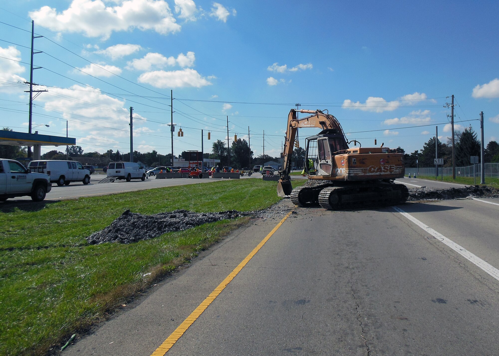 Heavy machinery removes pavement from the south end of SR 444 near Dayton Yellow Springs Road.  The former two-lane highway will be connected to Spruce Way to facilitate the internal base traffic flow. (photo by Mike Libecap) 