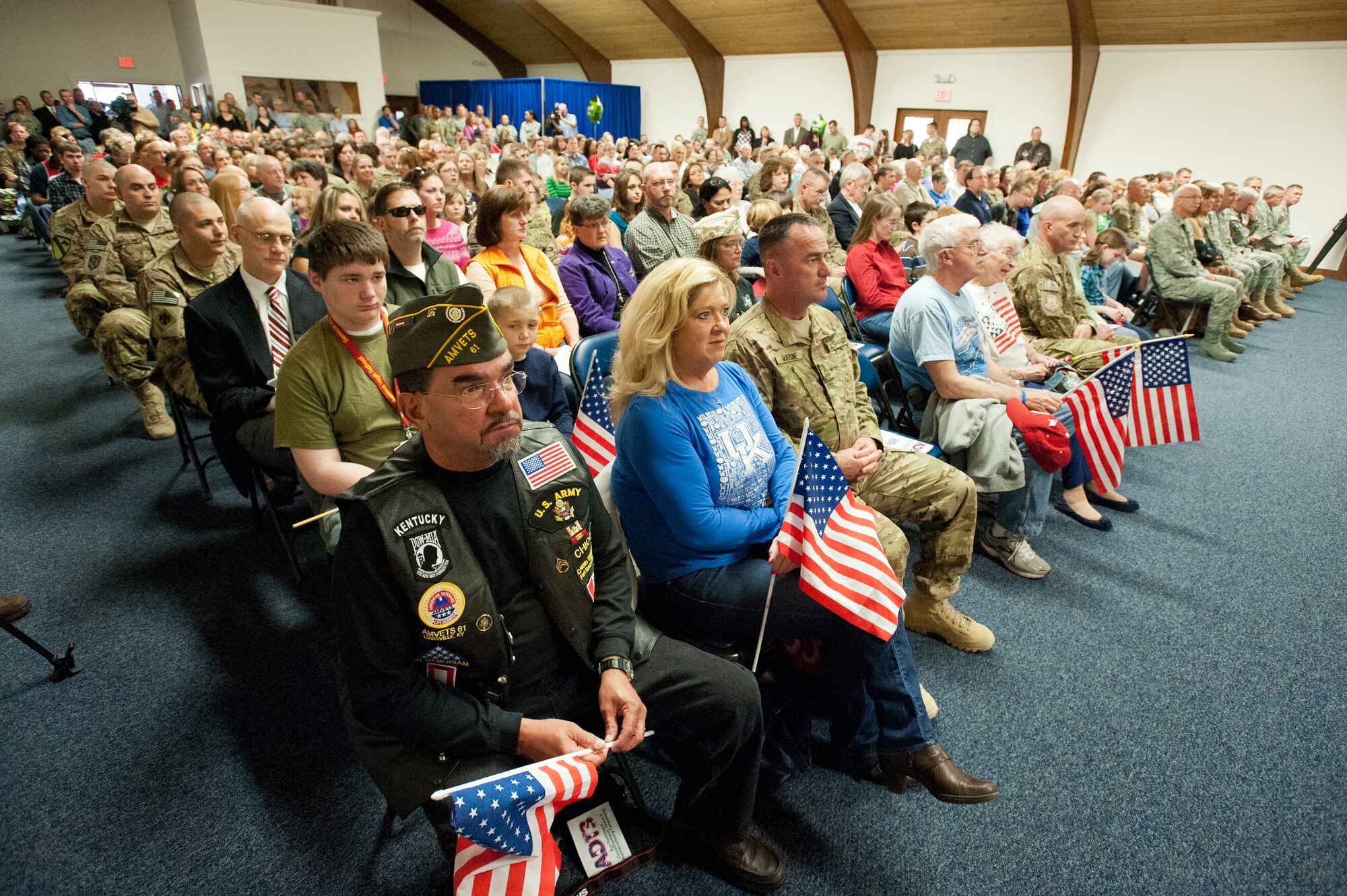 Hundreds of friends and family members gather at the Kentucky Air National Guard Base in Louisville, Ky., Feb 28, 2012, to welcome home 58 members of the Kentucky National Guard's Agribusiness Development Team 3. The team has been in Afghanistan for the past nine months, helping Afghan farmers develop sustainable agriculture. The group was instrumental in coordinating the first-ever commercial mulberry harvest in the Panshir Valley, producing 75 metric tons of mulberries and netting $45,000 for local farmers. (U.S. Air Force photo by Maj. Dale Greer)