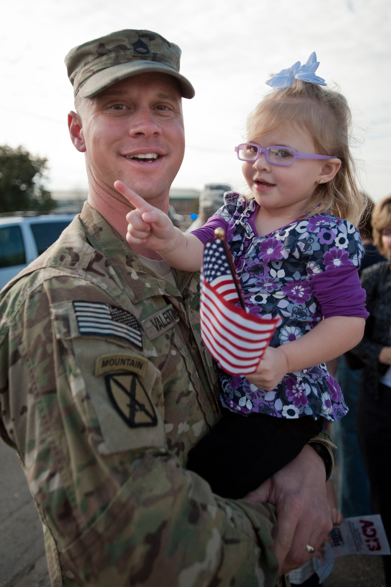 Staff Sgt. Jeff Valentine holds his daughter, Taylor, for the first time in nine months during a welcome-home ceremony held Feb 28, 2012, at the Kentucky Air National Guard Base in Louisville, Ky. Valentine was one of 58 Kentucky Army and Air National Guard Soldiers and Airmen who have been deployed to Afghanistan as part of the Kentucky National Guard's Agribusiness Development Team 3. The team has been in Afghanistan since mid-2011, helping Afghan farmers develop sustainable agriculture. The group was instrumental in coordinating the first-ever commercial mulberry harvest in the Panshir Valley, producing 75 metric tons of mulberries and netting $45,000 for local farmers. (U.S. Air Force photo by Maj. Dale Greer)
