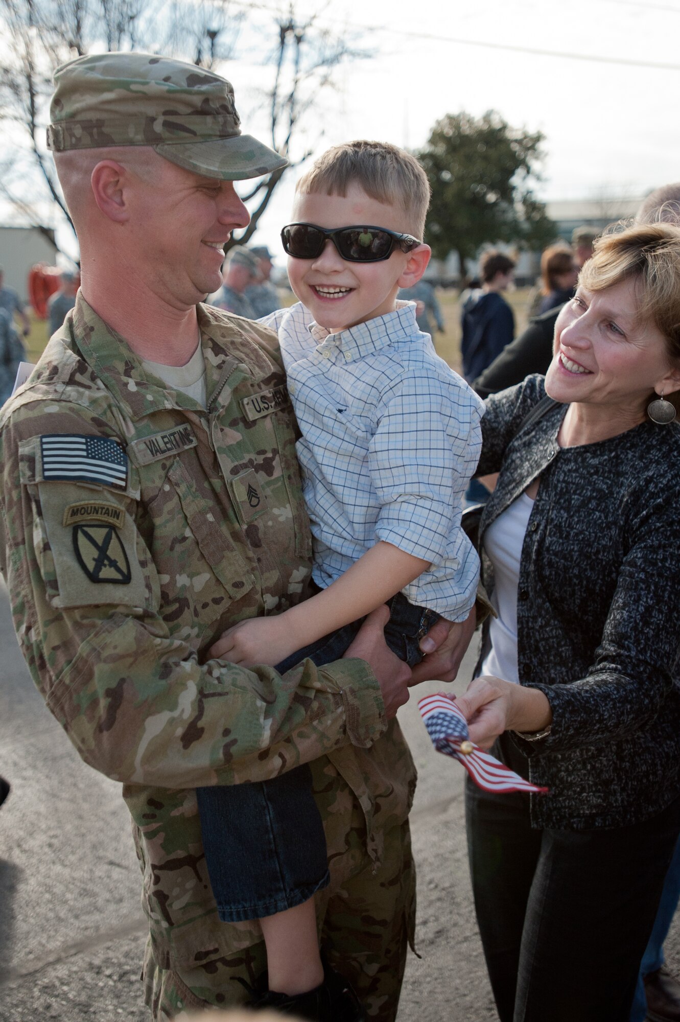 Staff Sgt. Jeff Valentine greets his son for the first time in nine months during a welcome-home ceremony held Feb 28, 2012, at the Kentucky Air National Guard Base in Louisville, Ky. Valentine was one of 58 Kentucky Army and Air National Guard Soldiers and Airmen who have been deployed to Afghanistan as part of the Kentucky National Guard's Agribusiness Development Team 3. The team has been in Afghanistan since mid-2011, helping Afghan farmers develop sustainable agriculture. The group was instrumental in coordinating the first-ever commercial mulberry harvest in the Panshir Valley, producing 75 metric tons of mulberries and netting $45,000 for local farmers. (U.S. Air Force photo by Maj. Dale Greer)