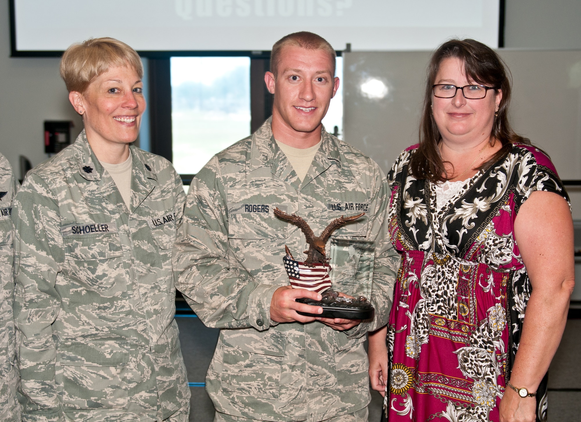 Senior Airman Nathan Rogers, an aerial porter for the Wisconsin Air Guard's 128th Logistics Readiness Squadron, receives the first-annual Chief Master Sergeant Tommy Downs Award for Excellence at the Logistics Readiness University in Savannah, Ga., on June 27, 2012. Also pictured are his commander, Lt. Col. Betsy Schoeller, and Janet Downs, wife to the late Chief Downs, a Kentucky Air Guardsman who was instrumental in founding the school. (U.S. Air Force photo by Master Sgt. Philip Speck)