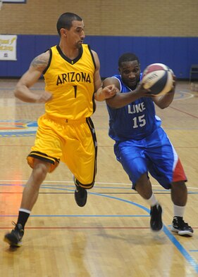 Jeffrey Ragin,56th Equipment Maintenance Squadron, avoids the defender during the basketball game against the Arizona Scorpions Oct. 06, 2012 at the Bryant Fitness Center on Luke Air Force Base, Ariz., The play resulted in two points scored by Ragin. (U.S. Air Force photo by Airman 1st Class Devante Williams)